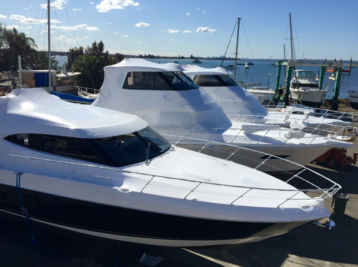 Three wrapped cruisers at a marina