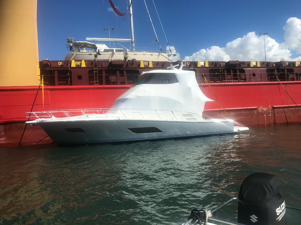 Wrapped cruiser beside a cargo ship